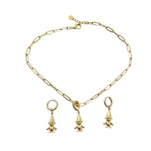 May include: A gold-toned jewelry set consisting of a paperclip chain necklace and two matching hoop earrings. Each piece features a small, three-dimensional troll figurine charm. The necklace clasp includes a small, clear stone accent.
