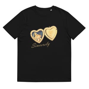 May include: A black short-sleeve t-shirt featuring a graphic of an open gold heart-shaped locket. The left side of the locket displays a vintage-style image of a person holding a child, while the right side shows a rose. The word Sincerely is printed below.