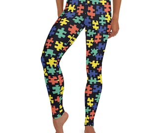 May include: Black leggings with a colorful puzzle piece pattern. The puzzle pieces are in shades of yellow, blue, green, and orange.