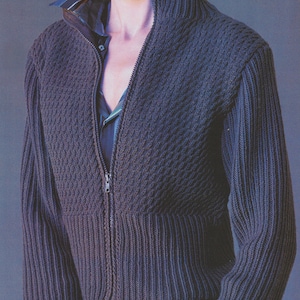 May include: A dark blue knitted zip-up jacket with a ribbed texture and a high collar.