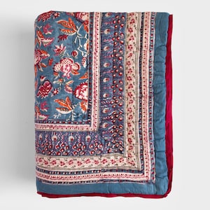 May include: A blue and red floral patterned quilt with a red border. The quilt is made of cotton and has a quilted design.
