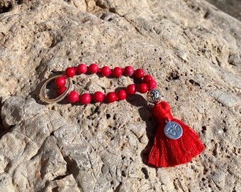 Key ring - Mini Mala "Magnesite" with hematite lava bead and small Om coin on a red cotton tassel