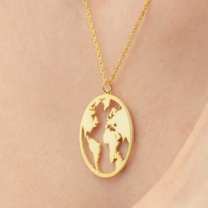May include: A gold necklace with a pendant shaped like the world. The pendant is cut out to show the continents.