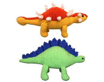 May include: Two crocheted dinosaur toys. One is yellow with red and white spikes and the other is green with blue spikes.
