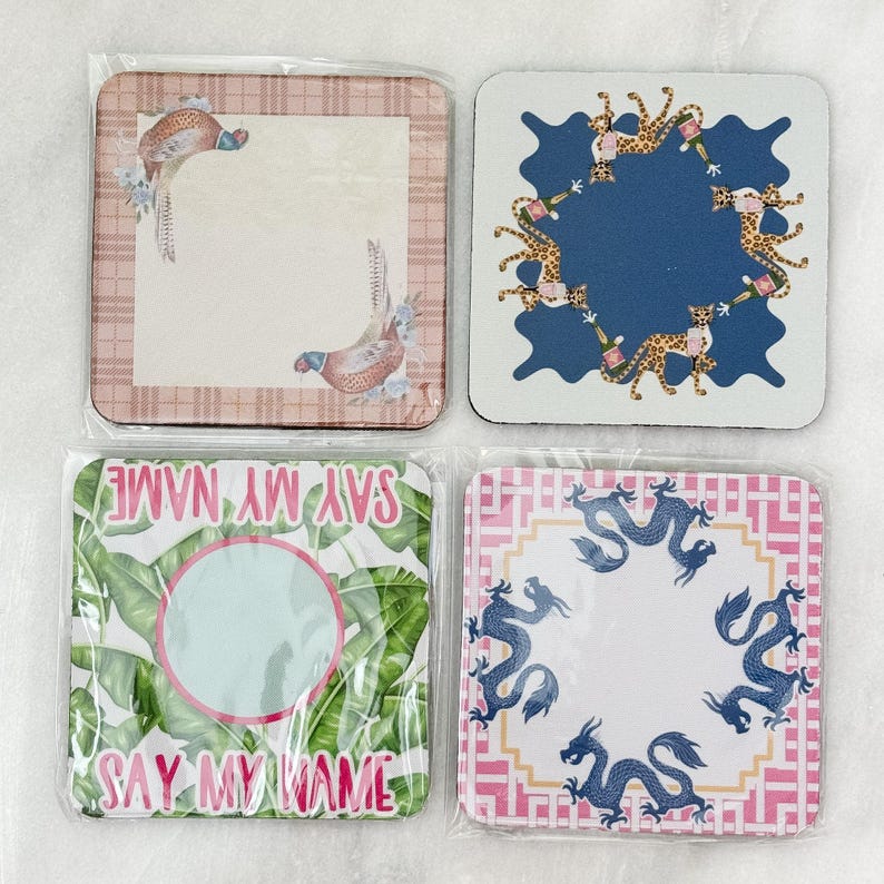 May include: Set of four square coasters with various designs. One features pheasants, another has leopard print, a third says "SAY MY NAME", and the last has blue dragons. Each coaster is packaged in clear plastic.
