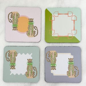 May include: Set of four square coasters with unique designs. One coaster features a cheetah illustration with a green bow, another has a horse bit design, and two others have cheetahs with a white space for text.