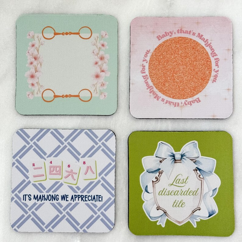May include: Set of four square coasters with various designs. One has a floral frame and equestrian-themed accents. Another features a textured circle with the text "Baby, that's Mahjong for you." The third has Chinese characters and the text "IT'S MAHJONG WE APPRECIATE!" The last has a bow and the text "Last discarded tile."