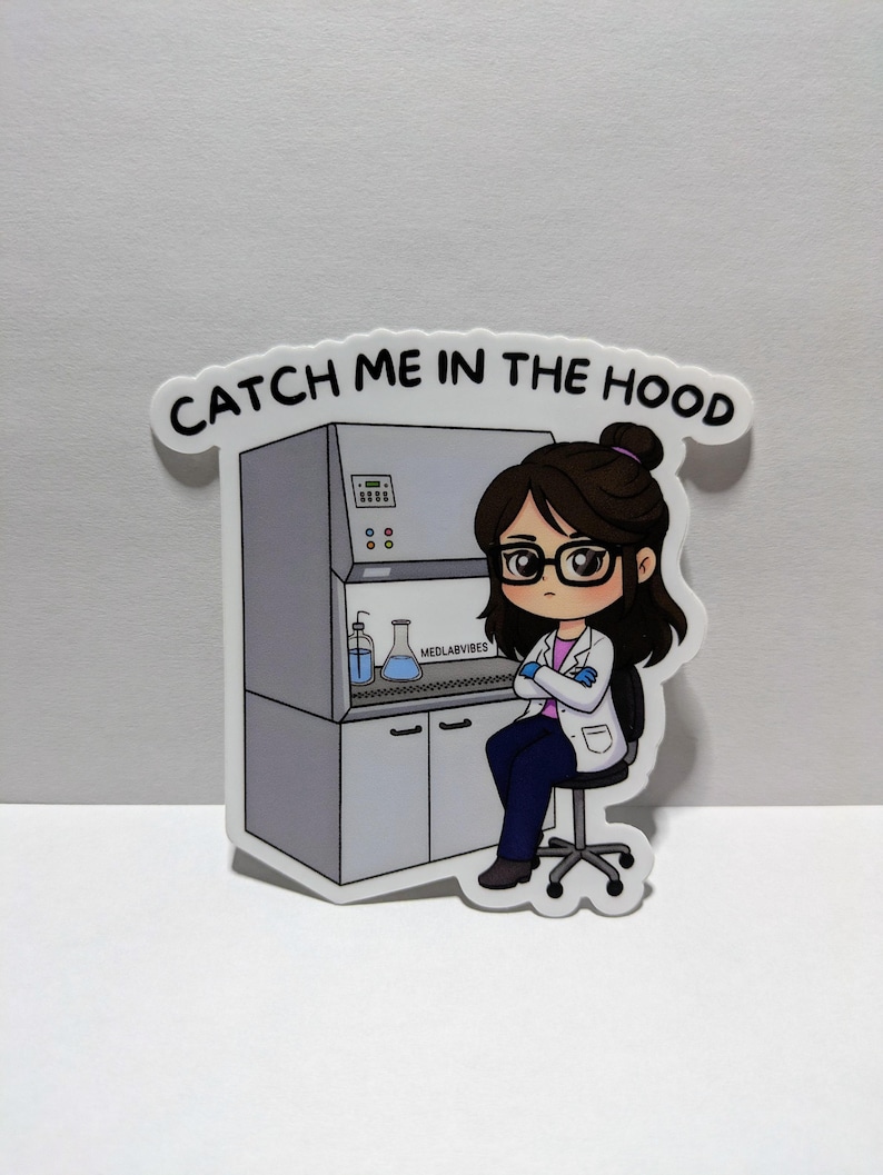 May include: A sticker with a cartoon image of a person in a lab coat and glasses, seated before a laboratory hood. The sticker reads "CATCH ME IN THE HOOD" and "MEDLABVIBES".