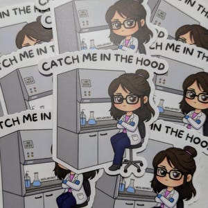 May include: A collection of stickers with a cartoon illustration of a person in a lab coat and glasses, in front of a laboratory hood. The text "CATCH ME IN THE HOOD" is displayed. The stickers are white with a grey background.