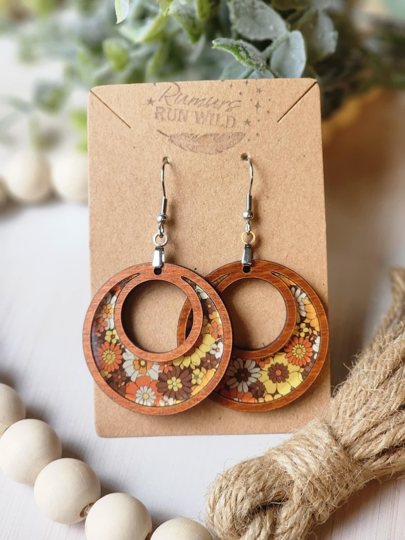 70s retro earrings with brown, orange, and yellow flowers inside a cider stained wood open circle earring.