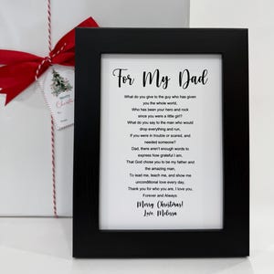 May include: A framed print with a black frame and a white background. The print features a poem about a father, with the text "For My Dad" at the top. The poem ends with "Merry Christmas! Love. Melissa".