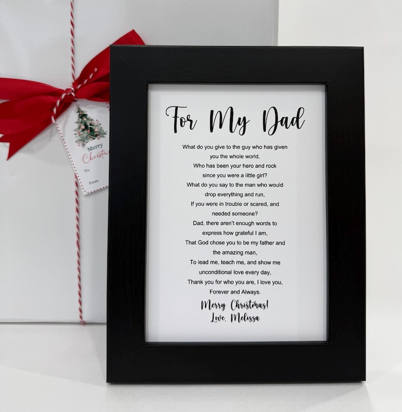 May include: A framed print with a black frame and a white background. The print features a poem about a father, with the text "For My Dad" at the top. The poem ends with "Merry Christmas! Love. Melissa".