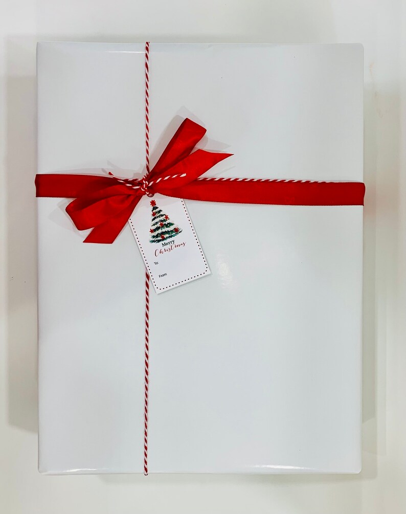 May include: White gift box with a red ribbon and a gift tag that says "Merry Christmas".