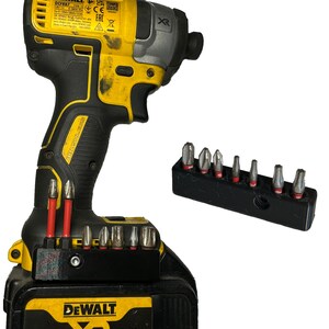 May include: A yellow and black DeWalt XR 18V 4.0Ah Li-Ion cordless drill with a black and silver impact driver and a black bit holder with a variety of bits.
