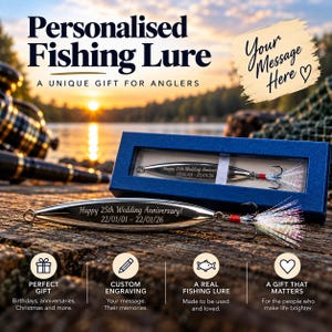 May include: A silver-toned metal fishing lure with a treble hook and iridescent fibers, engraved with the text "Happy 25th Wedding Anniversary! 22/01/01 - 22/01/26". The lure is presented both outside and inside a rectangular blue cardboard box.