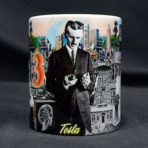 May include: A white ceramic mug with a colorful collage design featuring a portrait of Nikola Tesla, a cityscape, and the number "3". The mug has the word "Tesla" printed in yellow at the bottom.