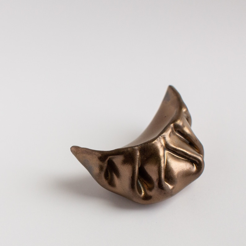 Ceramic recreations of chinese-style dumplings, in a variety of glaze colors.
