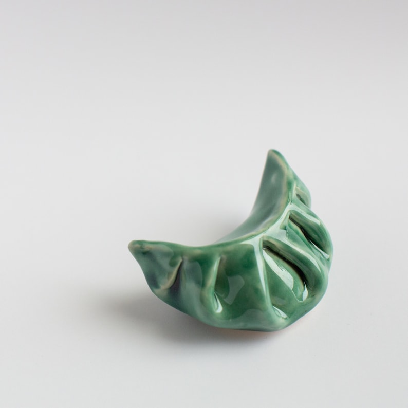 Ceramic recreations of chinese-style dumplings, in a variety of glaze colors.
