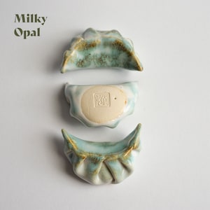 Ceramic recreations of chinese-style dumplings, in a variety of glaze colors.