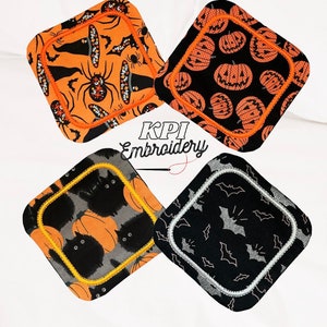 May include: Four Halloween-themed square coasters. Each coaster features a different design: spiders and witch hats on orange, jack-o'-lanterns on black, black cats and pumpkins on grey, and bats on black. The coasters have a decorative border and the text "KPI Embroidery".