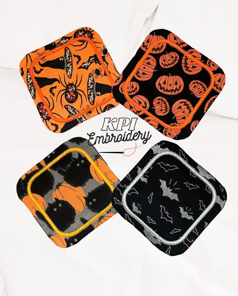 May include: Four Halloween-themed square coasters. Each coaster features a different design: spiders and witch hats on orange, jack-o'-lanterns on black, black cats and pumpkins on grey, and bats on black. The coasters have a decorative border and the text "KPI Embroidery".