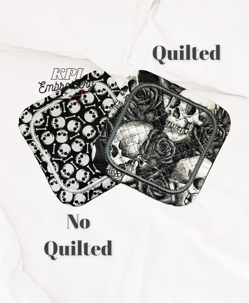May include: Two square pot holders with skull and bone patterns. One is black and white with skulls and bones, the other is black and grey with skulls and roses. The pot holders have a grey border.