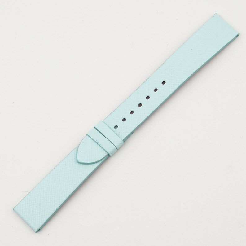 May include: A light blue leather watch strap with stitching detail.