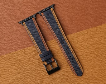 May include: Two leather watch bands with a dark blue base and orange stitching. The bands are designed for Apple Watches.
