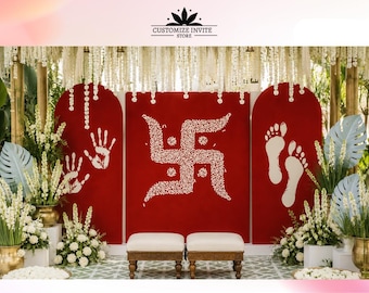 May include: A wedding ceremony backdrop featuring red panels with white handprints, a Swastika symbol, and footprints. The scene is decorated with white flowers, greenery, and two small benches. The text "CUSTOMIZE INVITE STORE" is at the top.