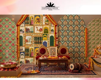 May include: A decorative event backdrop set featuring four arched panels with intricate patterns and illustrations, including a central panel with gold-toned frames, marigold garlands, two ornate chairs, a wooden table, and a brass bowl.