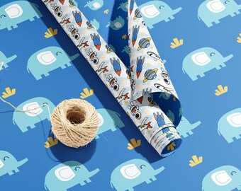 May include: A roll of blue and white wrapping paper with a pattern of elephants and rockets. A ball of twine is on the blue wrapping paper.