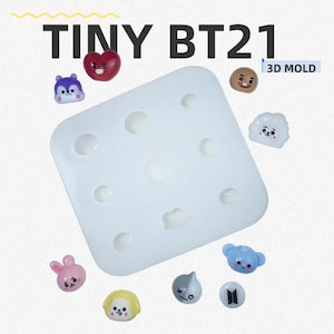 May include: A white square silicone 3D mold labeled TINY BT21 3D MOLD, featuring multiple circular and character-shaped cavities. Surrounding the mold are various small, colorful, three-dimensional character figures including a red heart, a blue face, and a yellow head.