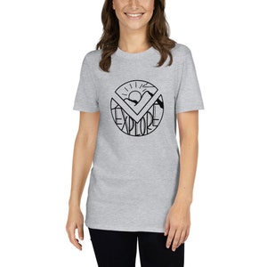 May include: A heather grey t-shirt with a black graphic of a sun, mountains, and the word "EXPLORE" in a circle.