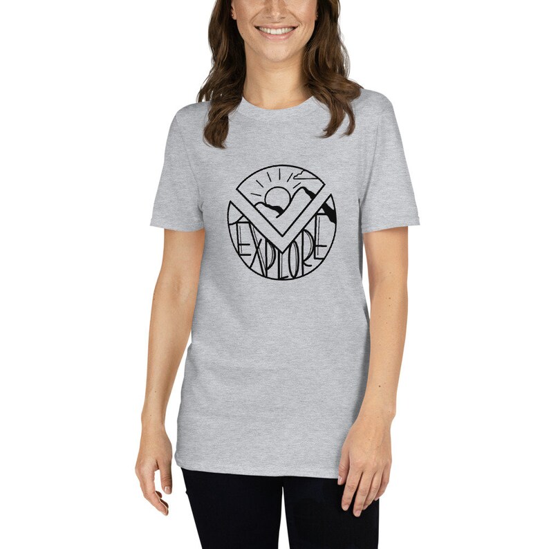May include: A heather grey t-shirt with a black graphic of a sun, mountains, and the word "EXPLORE" in a circle.