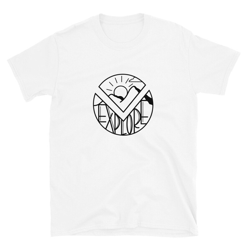 May include: White t-shirt with a black graphic design of a circle with the word "EXPLORE" written inside. The graphic also includes a sun, mountains, and a checkmark.