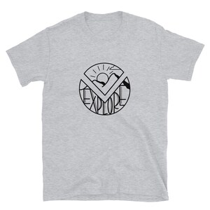 May include: A gray t-shirt with a black graphic of a sun, mountains, and the word "EXPLORE" in a circle.