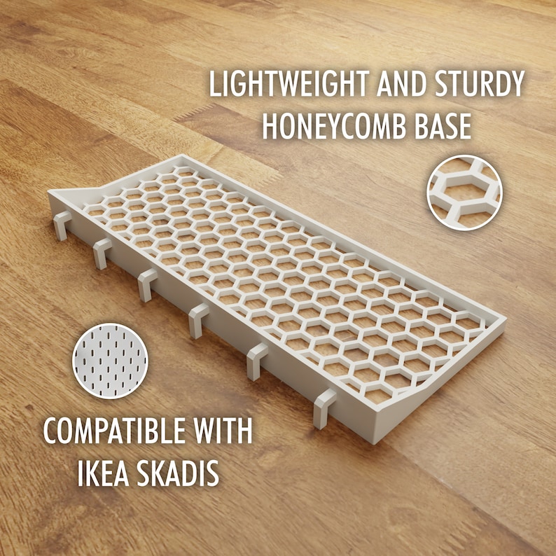 May include: White plastic shelf insert with a honeycomb design. The insert is compatible with IKEA SKADIS and is lightweight and sturdy.  "LIGHTWEIGHT AND STURDY HONEYCOMB BASE" and "COMPATIBLE WITH IKEA SKADIS" are printed on the wood surface.