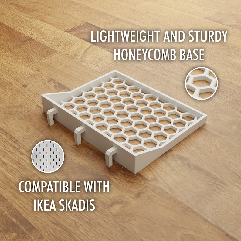 May include: White plastic shelf insert with a honeycomb design. The insert is compatible with IKEA SKADIS.
