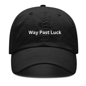 May include: A black baseball cap with a white embroidered phrase "Way Past Luck".