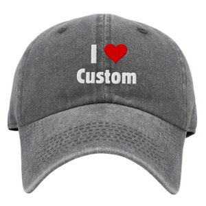 May include: A gray baseball cap with the text "I love Custom" embroidered in white with a red heart.
