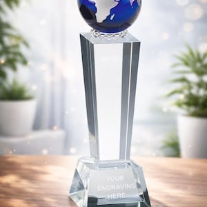 May include: A white ceramic mug with a black handle and the text "But First, Coffee" in a black, handwritten-style font. The mug is on a white surface.