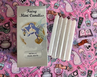 May include: A package of metallic pearl white fairy mini candles. The package features a fairy illustration and the text "Fairy Mini Candles" and "Metallic Pearl White".