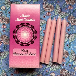 May include: A box of pink magic mini candles with a geometric design and the text "Magic Mini Candles Rose Universal Love".