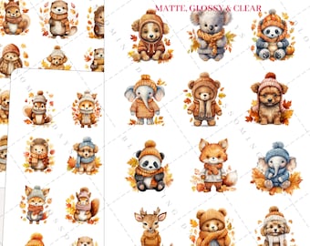 May include: A set of 12 autumn-themed stickers featuring various animals wearing hats and scarves. The animals include a fox, a deer, a panda, a bear, a squirrel, a dog, an otter, a hedgehog, and an elephant. The stickers are on a white background with fall leaves.