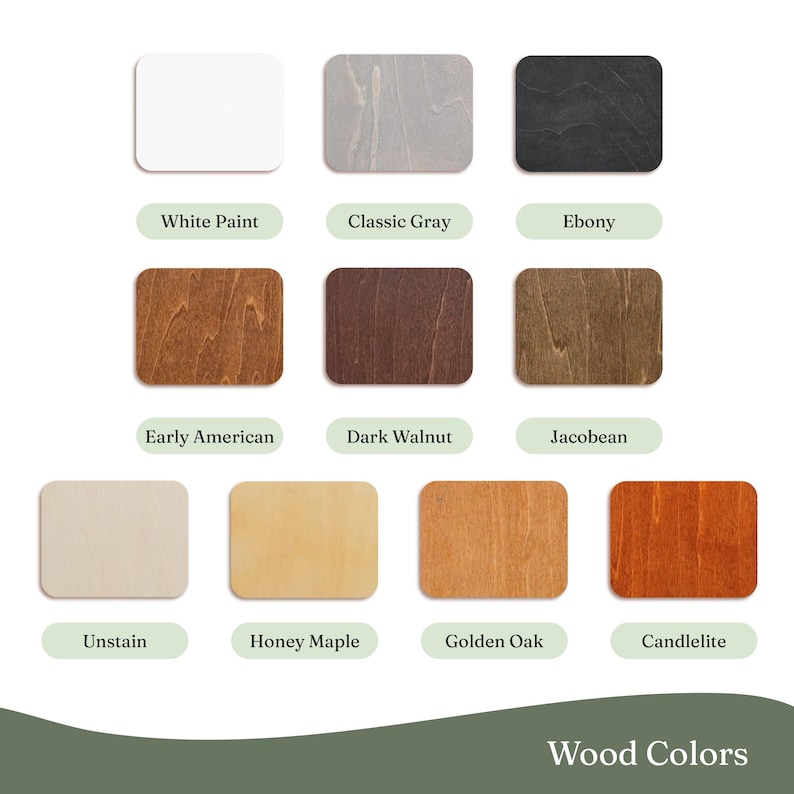 May include: A collection of wood color samples, each in a rectangular shape with rounded corners. The colors range from white and gray to various shades of brown and orange. Text labels identify each color, including "White Paint," "Ebony," and "Golden Oak."