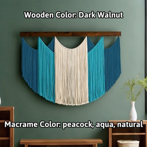 May include: A macrame wall hanging with a dark walnut wooden bar. The macrame features peacock, aqua, and natural colors. The text on the image says "Wooden Color: Dark Walnut" and "Macrame Color: peacock, aqua, natural".