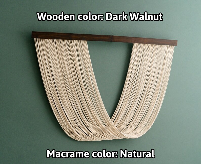 May include: A macrame wall hanging with a dark walnut wood frame. The macrame is made of natural colored cord and is shaped like a V. The text "Wooden color: Dark Walnut" and "Macrame color: Natural" is visible below the hanging.