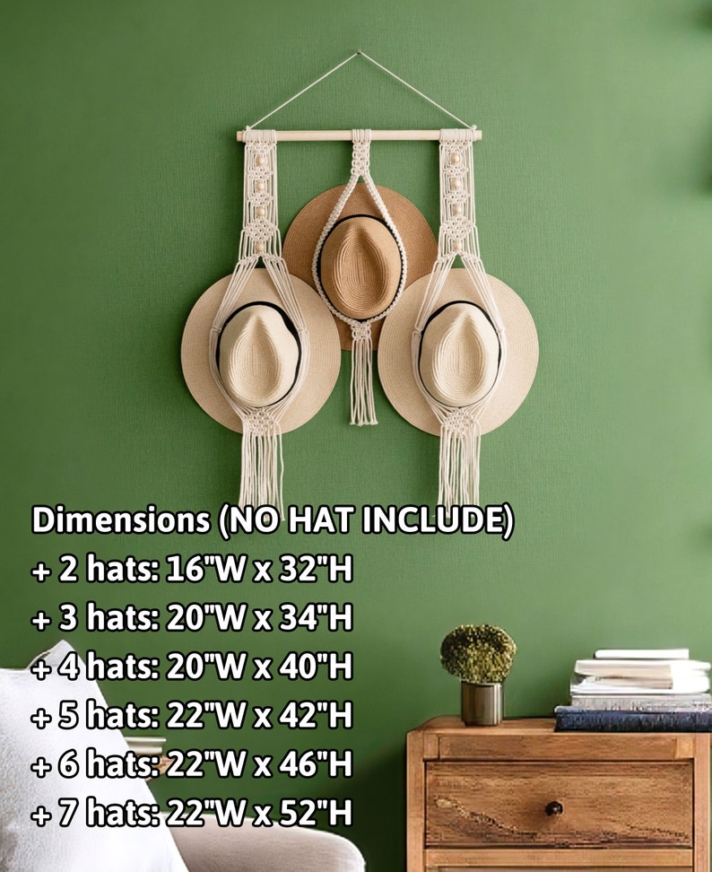 May include: Macrame hat holder with a wooden dowel and hanging rope, designed to hold multiple hats. The dimensions are listed in the image. The holder is displayed against a green wall, with three hats hanging from it.