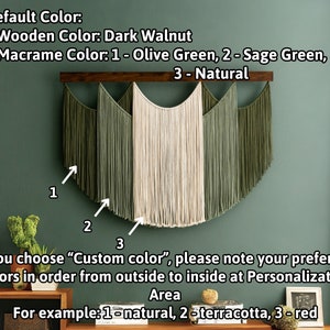 May include: A macrame wall hanging with a dark walnut wooden bar. The macrame features three colors: olive green, sage green, and natural. The text on the image says "Default Color" and "Custom Color" options are available.