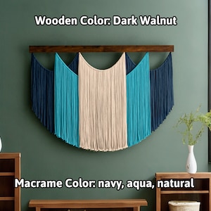May include: A macrame wall hanging with a dark walnut wooden bar. The macrame features navy, aqua, and natural colored cords, creating a semi-circular design. The text on the image reads "Wooden Color: Dark Walnut" and "Macrame Color: navy, aqua, natural."
